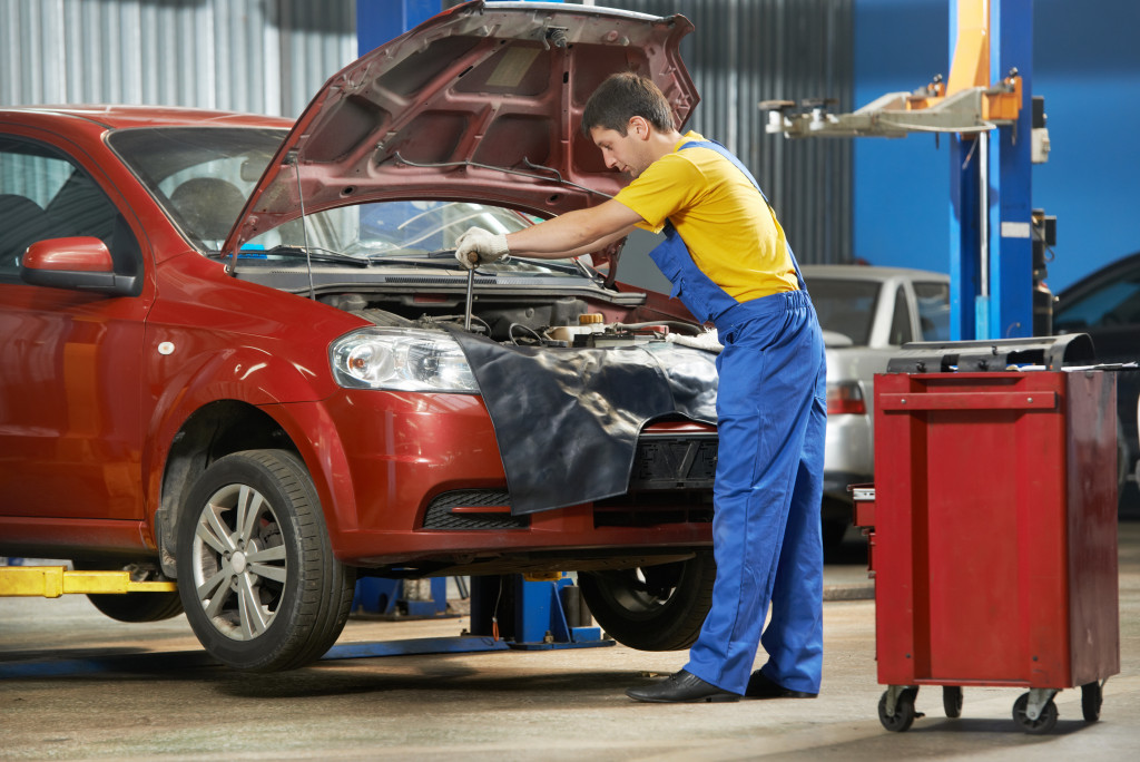 a man repairing a car